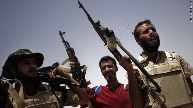 Libyan rebel fighters man a checkpoint at an area west of Ajdabiya on July 19, 2011