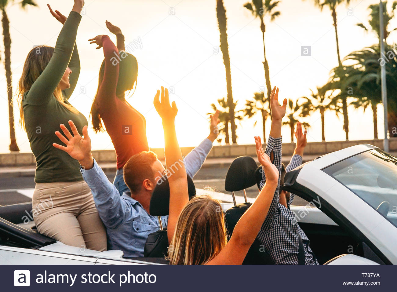 happy-friends-having-fun-in-convertible-car-in-....jpg