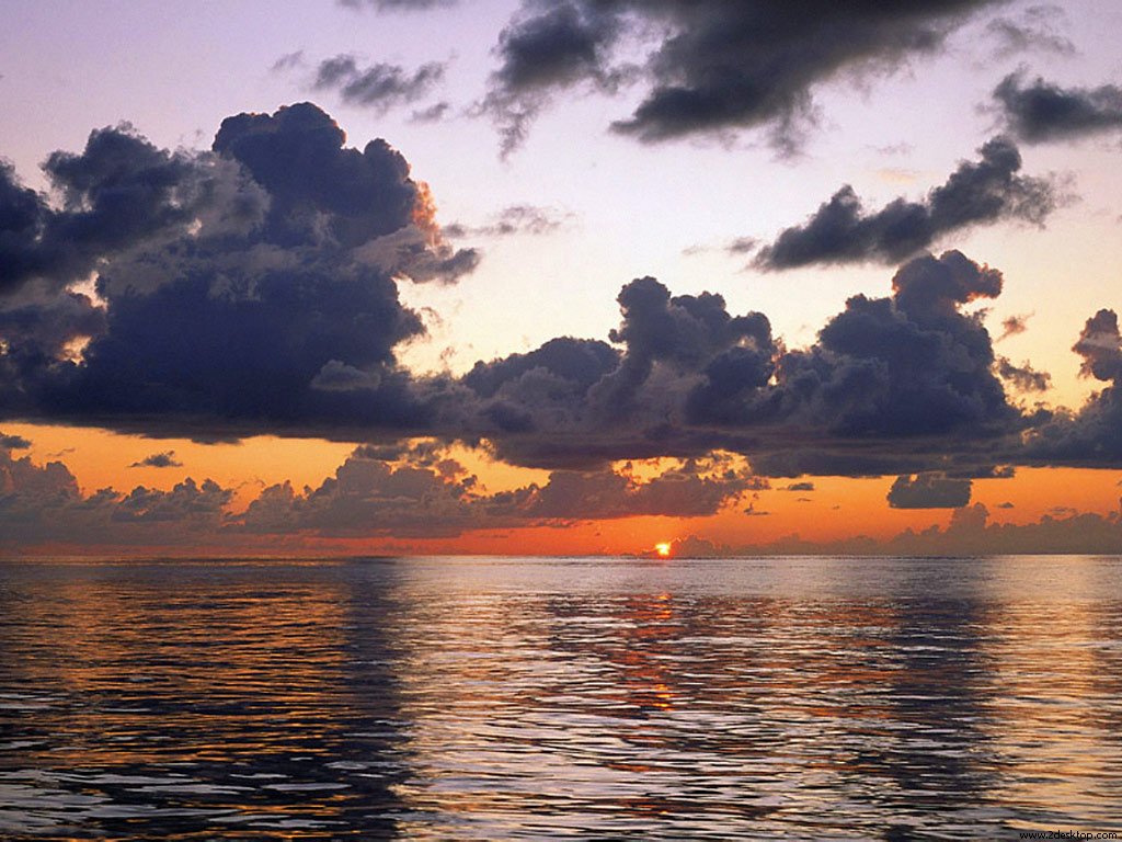 scattered_rain_clouds_at_sunset_pacific_ocean_....jpg